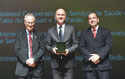 O diretor de Desenvolvimento da Unimed VTRP, Claus Dieter Dummer (ao centro), recebeu a medalha na quarta-feira à noite, em Porto Alegre (Foto: Vinicius Reis - Agência ALRS)
